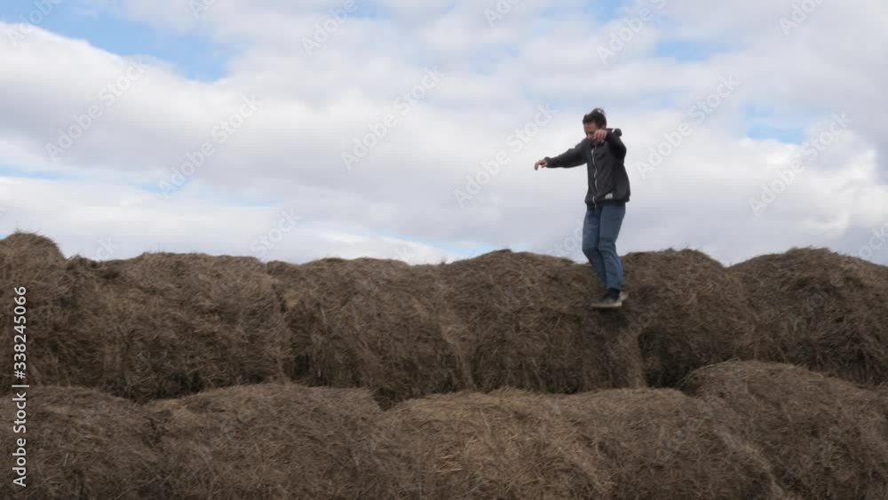 child play with a stack of straw against the sky child play with a stack of straw against the sky