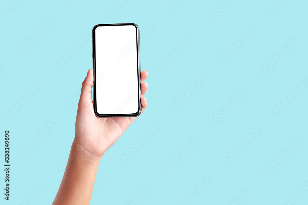 hand holding blank screen mobile phone isolate on blue background