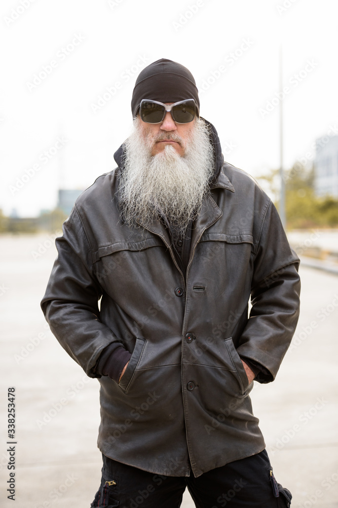 Portrait of mature bearded hipster man with sunglasses as rebel Portrait of mature bearded hipster man with sunglasses as rebel