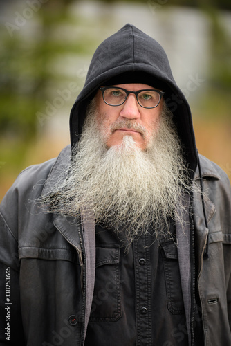 Face of mature bearded hipster man with eyeglasses