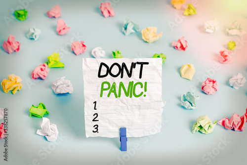 Text sign showing Don T Panic. Business photo showcasing suddenly feel so worried or frightened that you can not behave Colored crumpled papers empty reminder blue floor background clothespin