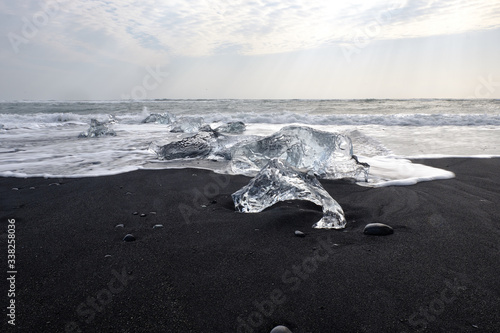 Ice floes and smaller chunks broken off larger icebergs tha thave floated out to the open ocean wash up on a black sand Iceland Beach © Jorge Moro
