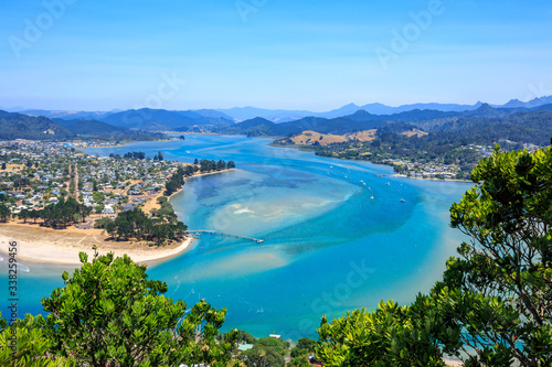 The neighboring coastal towns of Pauanui (left) and Tairua (right), separated by Tairua Harbour, on the Coromandel Peninsula, New Zealand © Michael
