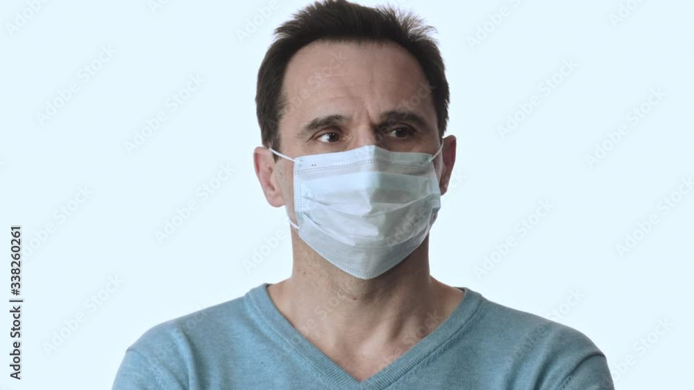 Man in protective mask afraid of coronavirus pandemic nervously looks around Man in protective mask afraid of coronavirus pandemic nervously looks around