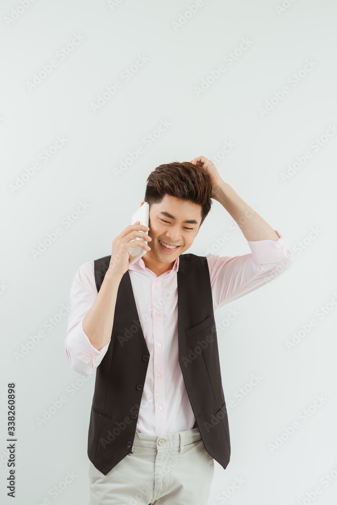 Handsome asian man using mobile over white background. Handsome asian man using mobile over white background.
