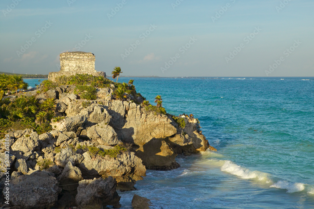 Templo del Dios del Viento Mayan ruins of Ruinas de Tulum (Tulum Ruins) in Quintana Roo, Mexico. The turquoise waters of the Caribbean Sea and beach to the right.