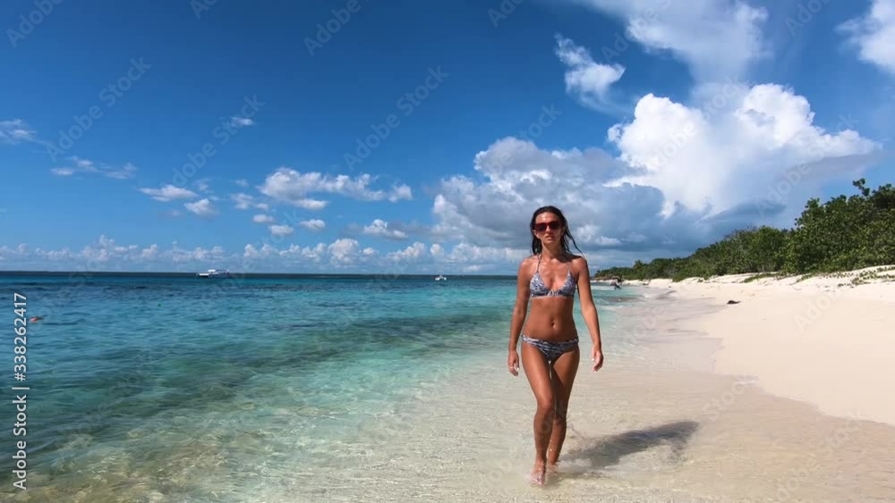 Slow motion - Young beautiful female feeling fun free and happy on tropical beach in ocean paradise. Travel sea background Atlantic ocean. Slow motion - Young beautiful female feeling fun free and happy on tropical beach in ocean paradise. Travel sea background Atlantic ocean.