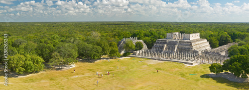 A panoramic view of the Temple of the Warriors out of jungle at Chichen-Itza. A Mayan ruin, in the Yucatan Peninsula, Mexico photo