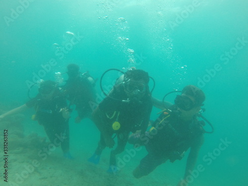 Bunch of scuba divers under water © Lazy Guruji