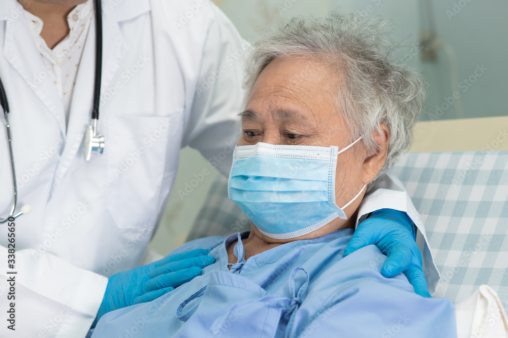 Doctor using stethoscope to checking Asian senior or elderly old lady woman patient wearing a face mask in hospital for protect infection and kill Novel Coronavirus (2019-nCoV) Covid-19 virus. Doctor using stethoscope to checking Asian senior or elderly old lady woman patient wearing a face mask in hospital for protect infection and kill Novel Coronavirus (2019-nCoV) Covid-19 virus.