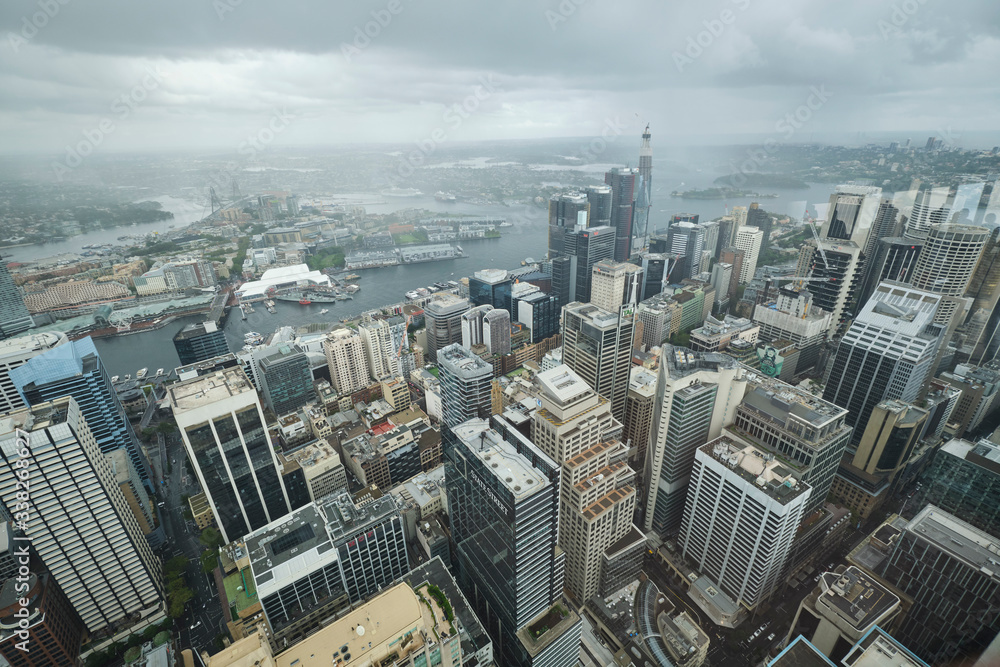 Fototapeta premium Overlooking Sydney CBD from tall viewing deck on grey sky overcast cloudy day
