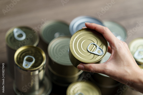 Woman hand with group of Aluminium canned food.