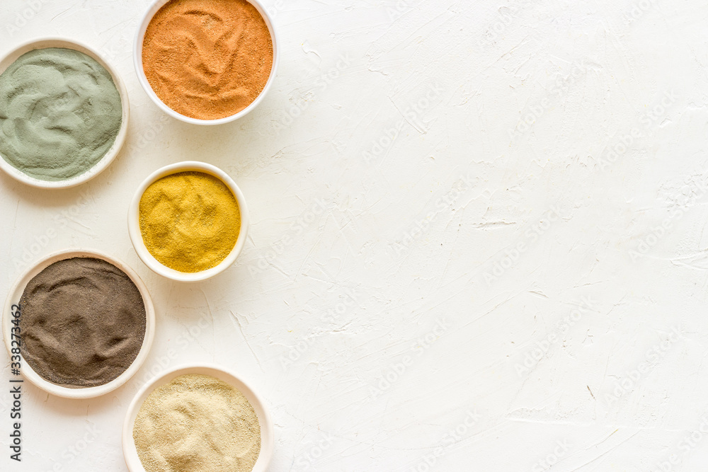 cosmetic clay - Yellow, red, white, blue and black dry powder - top-down flat lay space for text