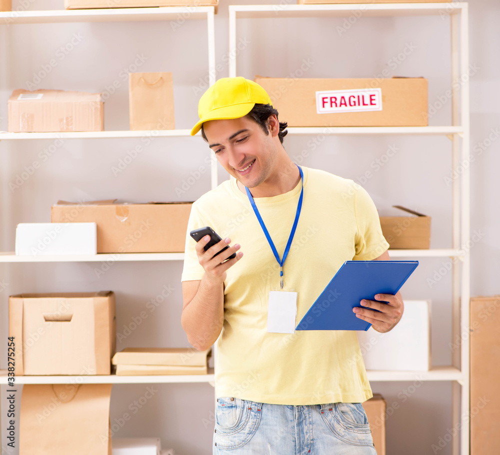 Handsome contractor working in box delivery relocation service Handsome contractor working in box delivery relocation service