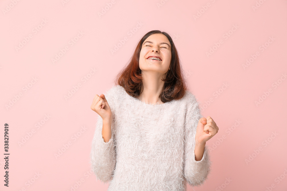 Happy teenage girl with dental braces on color background Happy teenage girl with dental braces on color background