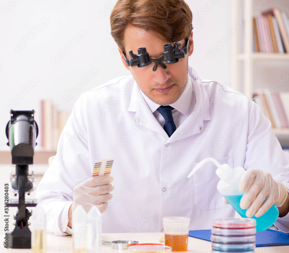 Chemist in the lab checking with ph strips Chemist in the lab checking with ph strips