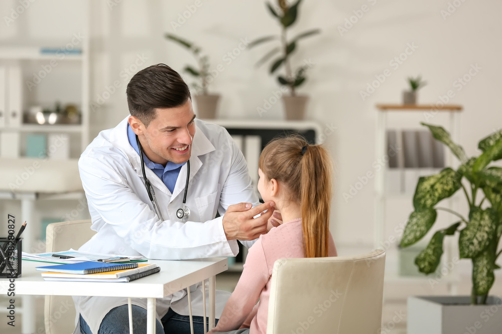 Pediatrician examining little girl in clinic Pediatrician examining little girl in clinic