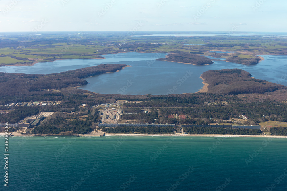 Prora’s monstrous holiday apartment complex photographed from the air. The miles long building was built in the Nazi era. In the background the beautiful lagoons of the Baltic island of Rügen.