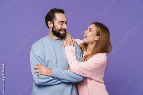 Optimistic pleased young loving couple isolated
