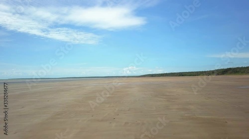 Aerial low fast shot of a drone flying at Gunn Point Beach, near Darwin, in the Northern Territory of Australia. photo