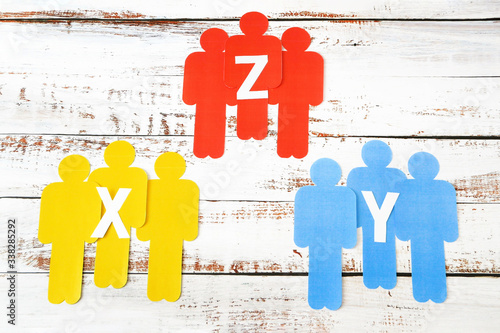 Obraz na plátně paper models of people of different nationalities on white wooden background, ge