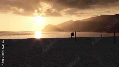 Sunset in Figueirinha beach with mountain ridge in the background. photo
