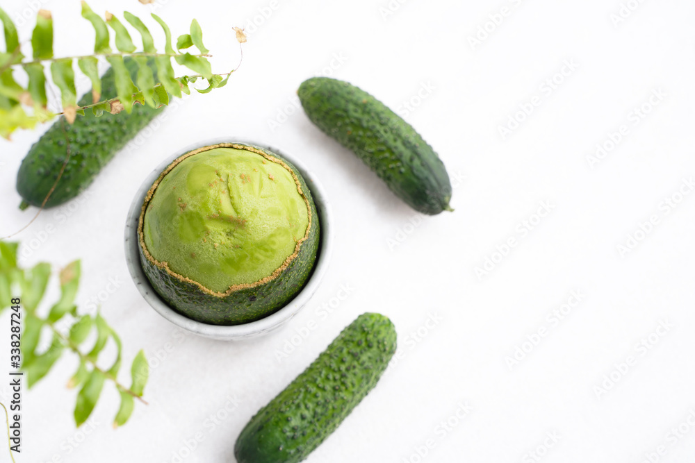 peeled on top of a ripe fresh avocado with a fleshy pulp and cucumber. Green concept. Flat lay.
peeled on top of a ripe fresh avocado with a fleshy pulp and cucumber. Green concept. Flat lay.