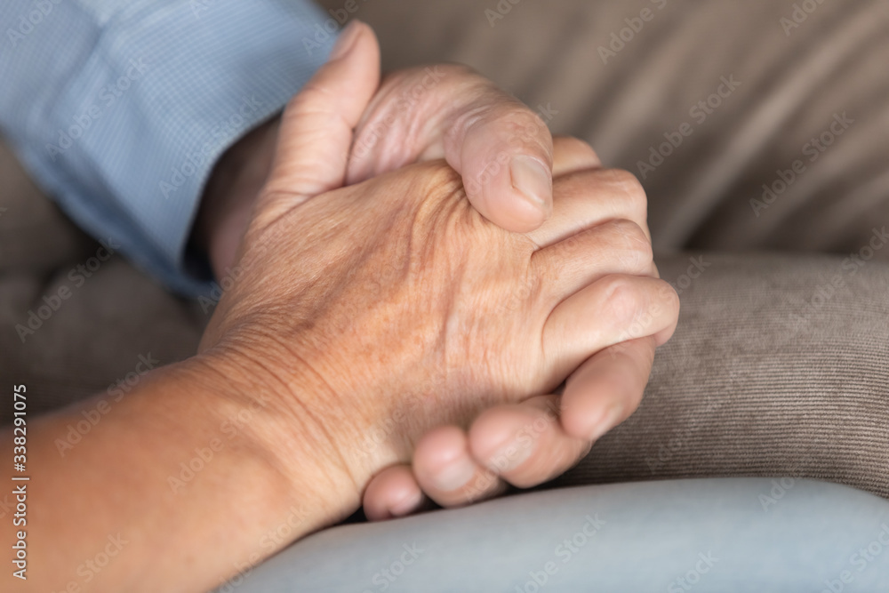 Fototapeta premium Close up older couple holding hands, loving spouses supporting and comforting each other, mature senior family expressing empathy and understanding, good trusted relationship in marriage