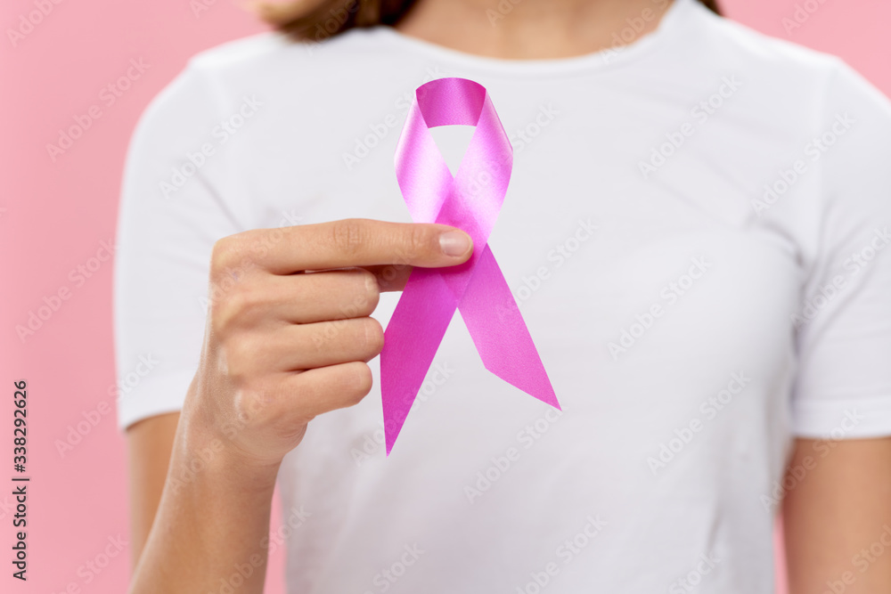 young woman holding pink ribbon young woman holding pink ribbon