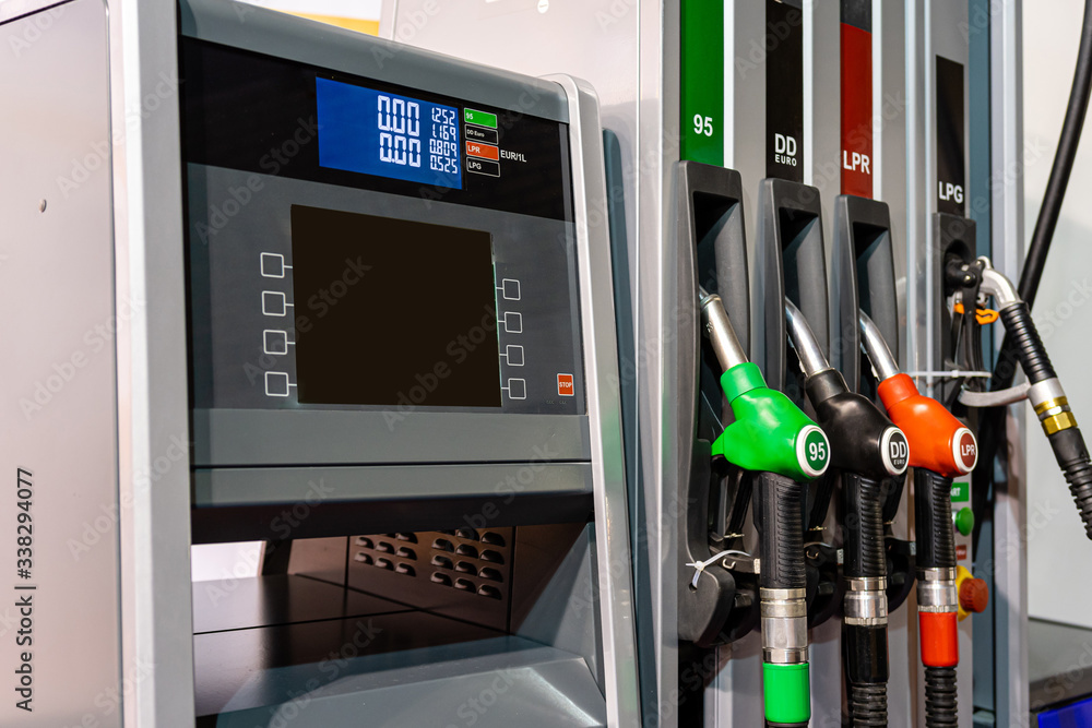 Colorful Petrol pump filling nozzles , Gas station in a service in daytime - image Colorful Petrol pump filling nozzles , Gas station in a service in daytime - image