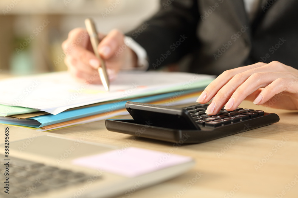 Bookkeepper hands calculating with calculator Bookkeepper hands calculating with calculator