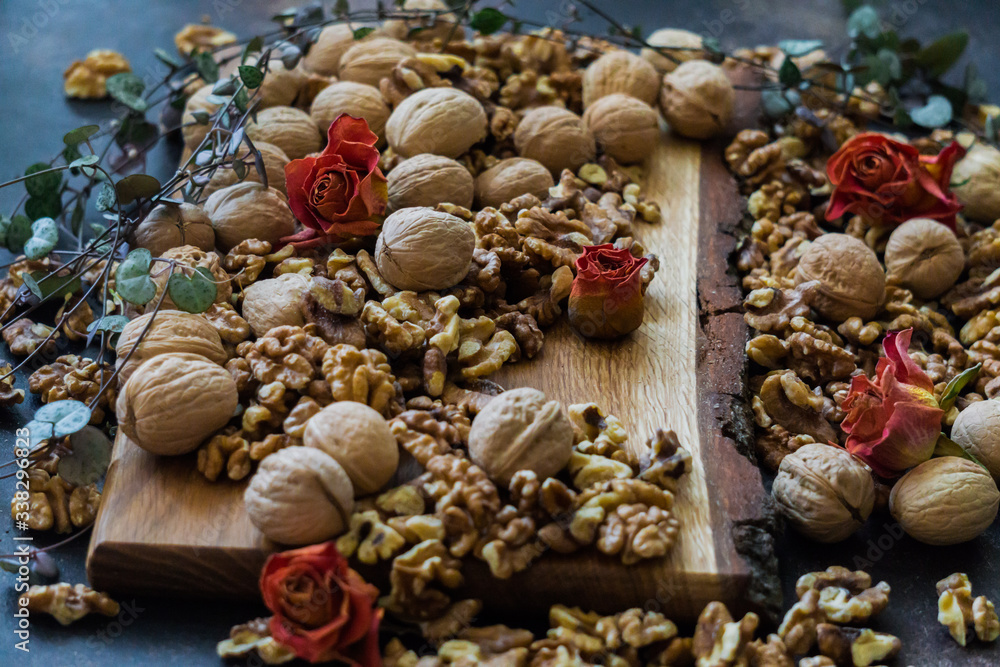 Shelled and shelled walnuts on a wooden board on the table. Healthy nutrition, vegetarianism, diet. Shelled and shelled walnuts on a wooden board on the table. Healthy nutrition, vegetarianism, diet.