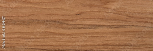 New natural nut veneer background in perfect light brown color. Natural wood texture, pattern of a long veneer.