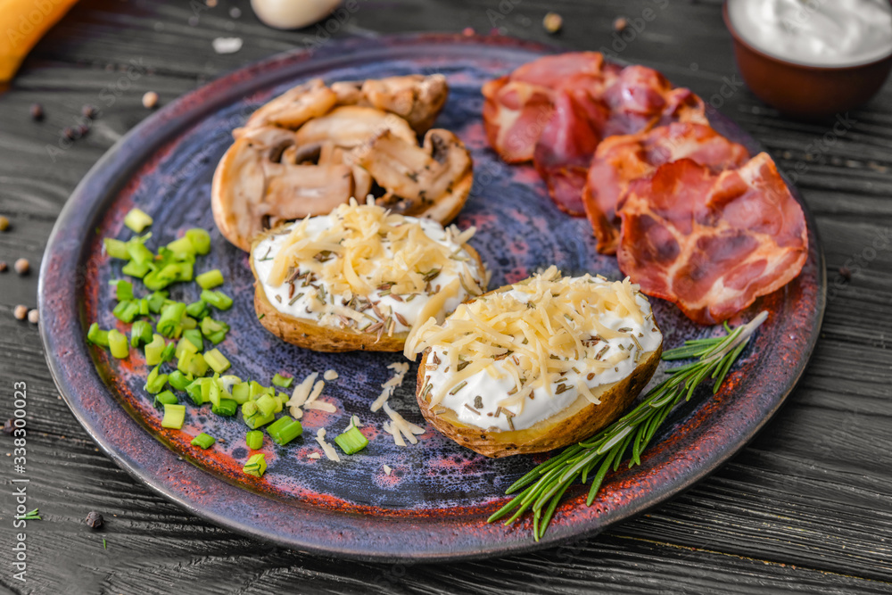 Tasty baked potato with sour cream, mushrooms and bacon on table Tasty baked potato with sour cream, mushrooms and bacon on table
