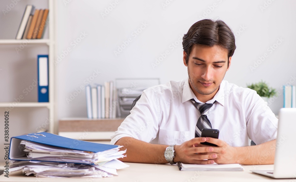 Young handsome businessman working in office Young handsome businessman working in office