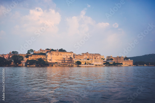 View of famous romantic luxury Rajasthan indian tourist landmark - Udaipur City Palace on sunset with cloudy sky. Udaipur, Rajasthan, India