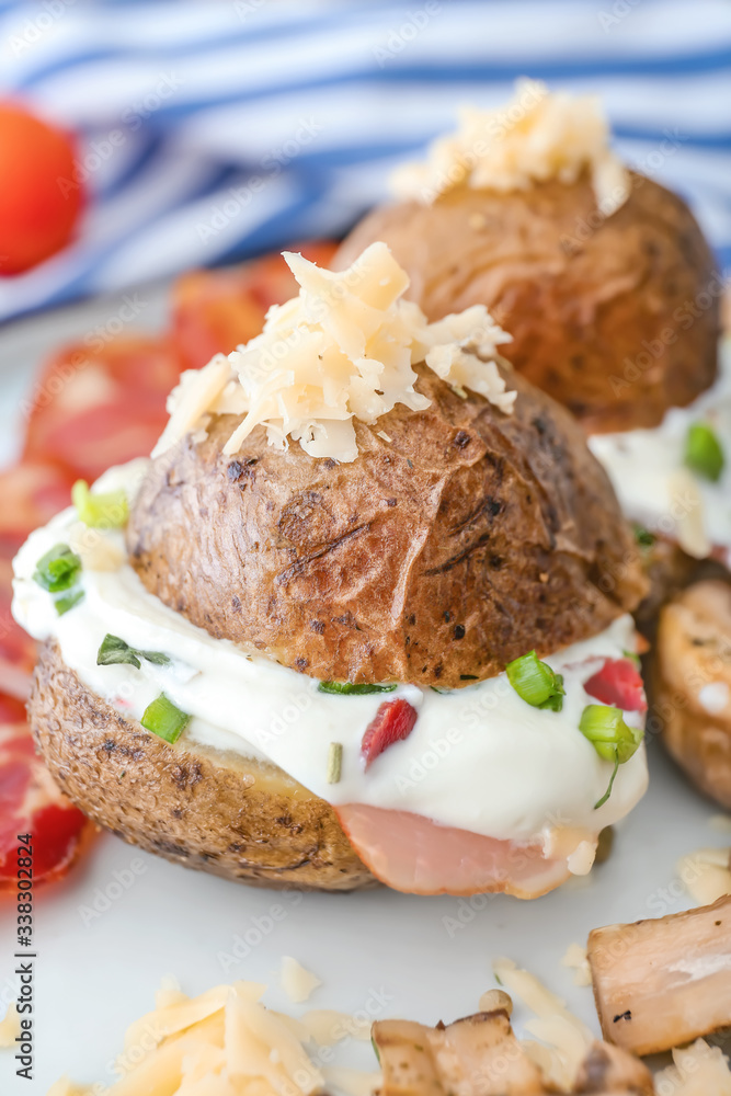 Tasty baked potato with sour cream on plate, closeup Tasty baked potato with sour cream on plate, closeup