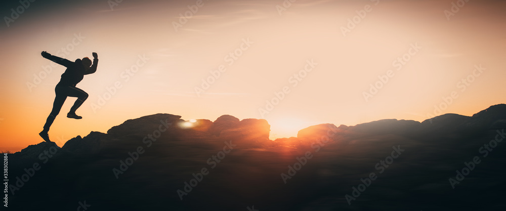 Banner, web page or cover template of Athlete run on the top of the hill during sunset - motivation, sport, energy concept photo with copy space. Copy space and panoramic ratio