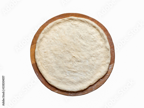 Isolated rolling out the raw dough on a wooden board