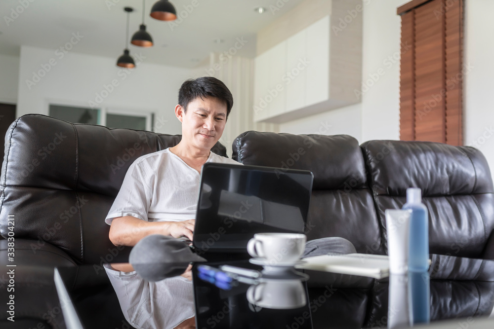 Business man working on laptop computer at home during quarantine for coronavirus. Work from home and social distancing concept. Business man working on laptop computer at home during quarantine for coronavirus. Work from home and social distancing concept.