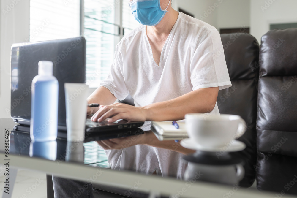 Business man working on laptop computer at home during quarantine for coronavirus. Work from home and social distancing concept. Business man working on laptop computer at home during quarantine for coronavirus. Work from home and social distancing concept.