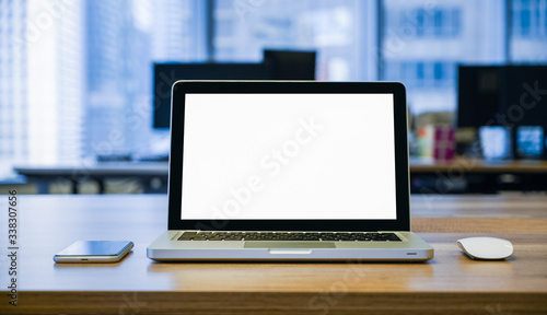 front view of laptop with blank screen on the table with mouse and mobile phone
