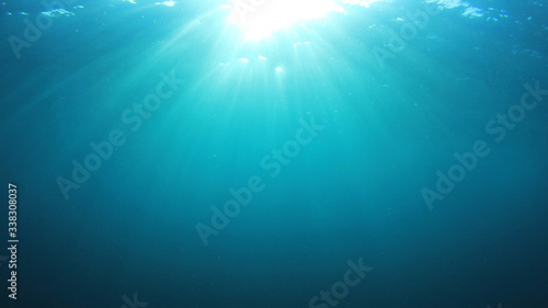 Underwater sunburst. Blue water background and sunlight 