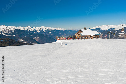 Alpine ski resort with cafe building on slope