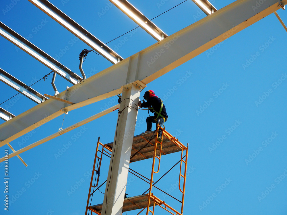 Man Working on the Working at height on construction site with blue sky Man Working on the Working at height on construction site with blue sky