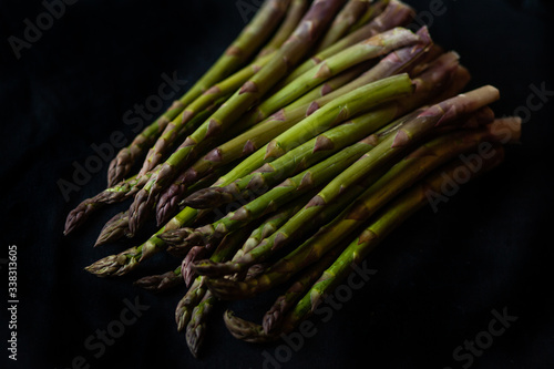 Fresh asparagus on the black background