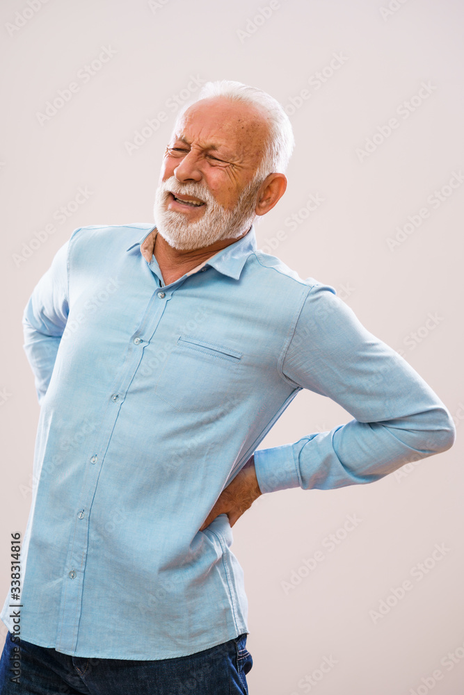 Portrait of senior man who is having pain in back. Portrait of senior man who is having pain in back.