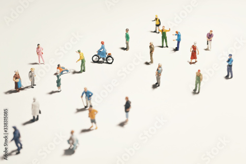 Top view of people  miniature toys  with long shadows keep distance away in public during sunrise or sunset.Social distancing   COVID-19 coronavirus outbreak spreading concept.
