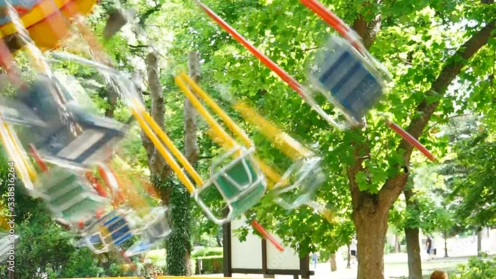 Attraction circular children's swing on chains in the summer park