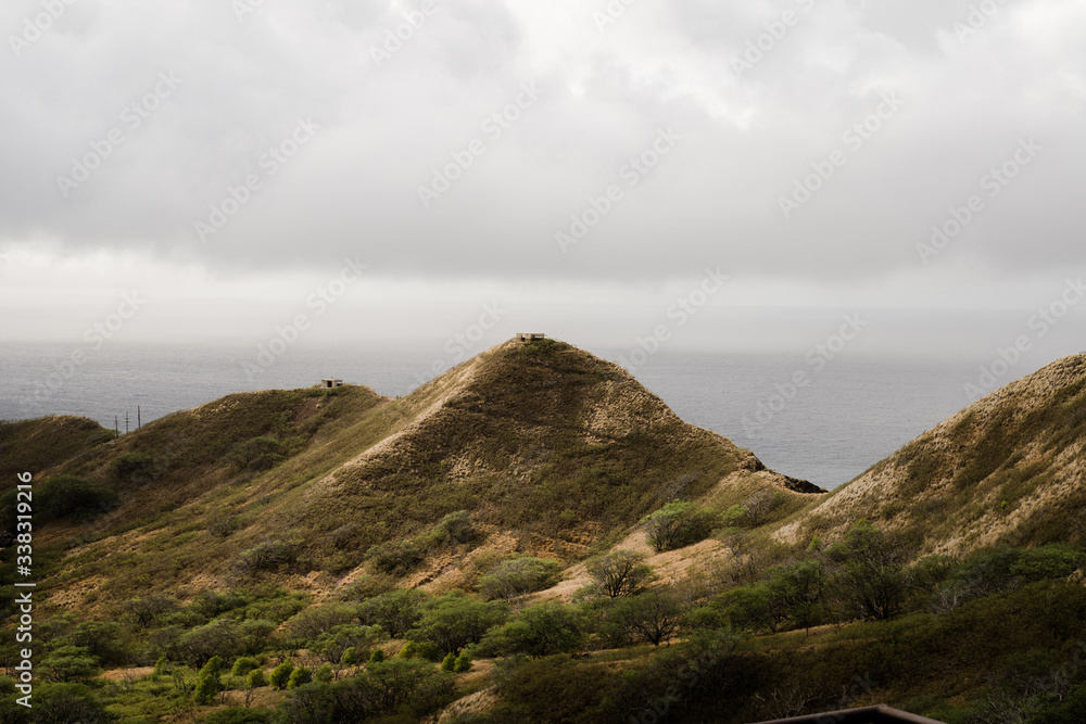 Moody mountain views from the top of the Diamond Head Crater Hike on an overcast, cloudy day.